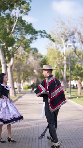 couple of huasos dancing Chilean cueca in the city square, Fiestas Patrias concept