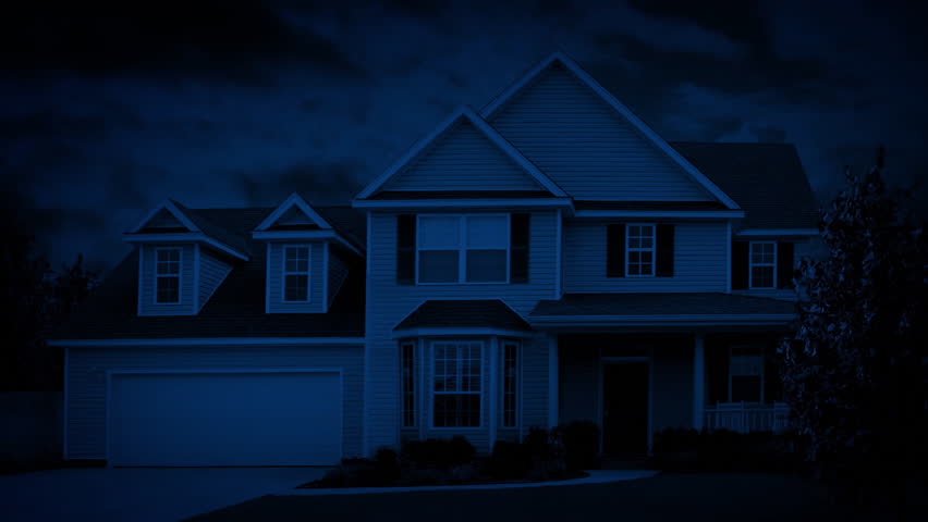 Light Turns On And Man Walks Past Window In House At Night