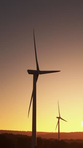 3D - Aerial flying at sunset over renewable energy wind farm wind turbines in Sandy Ridge. Pennsylvania. USA