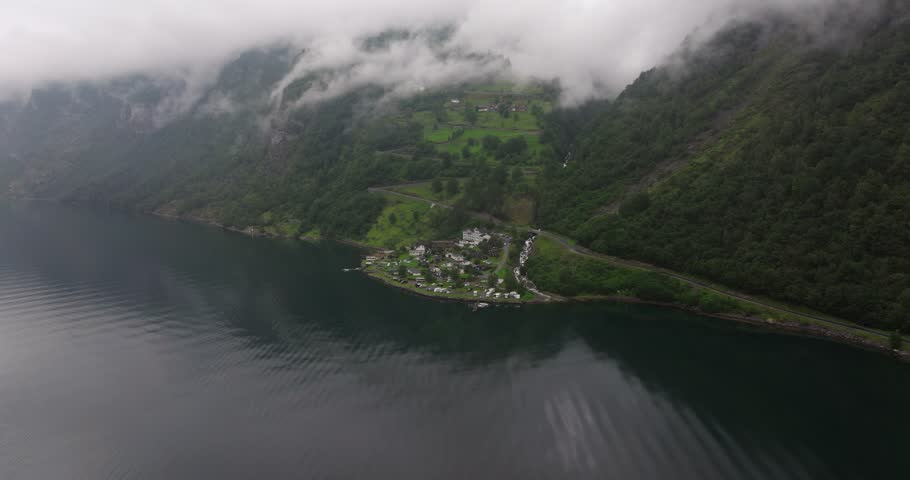 Aerial View Above Campground, Cabins, RVs. Geiranger, Norway. Overcast Foggy Day. Winding Mountain Road