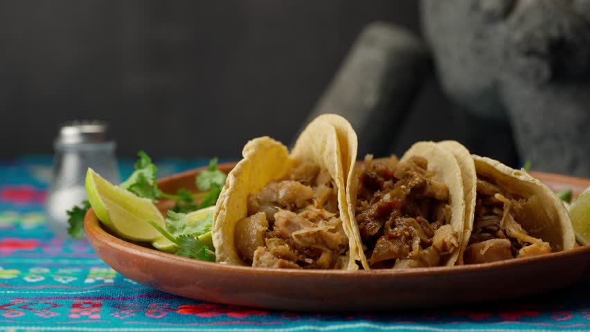 Preparing some Mexican carnitas tacos with spicy sauce