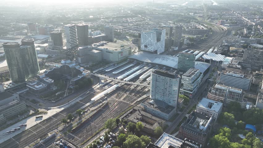 Utrecht central station, public transport and city skyline overview. Aerial drone video