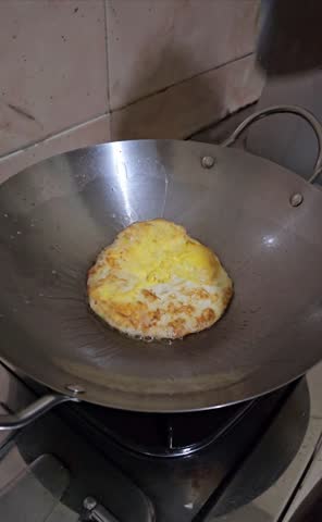 fry eggs in a stainless steel skillet. on a gas stove.