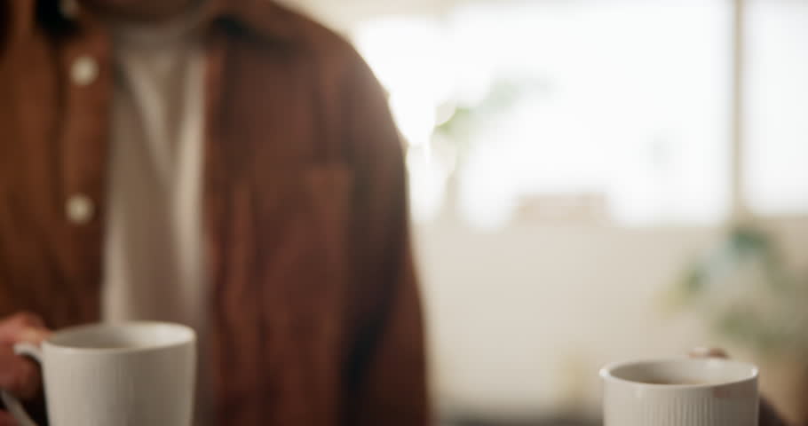 Morning, coffee and couple toast in home kitchen with conversation, cup and mug with drink. Relax, communication and love of people with cheers, house and marriage talking for breakfast plan with tea