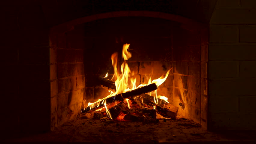 Flickering Flames Dancing in a Cozy Brick Fireplace. Warm Fire Burns in a Brick Fireplace, Creating a Cozy Ambiance With Glowing Flames and Inviting Warmth for Winter Nights