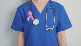 Pink October Breast Cancer Awareness month, woman doctor with pink Ribbon in hospital for support people life and illness. National cancer survivors month, Mother and World cancer day concept - Powered by Shutterstock - Get 15% off with code: PIKWIZARD15