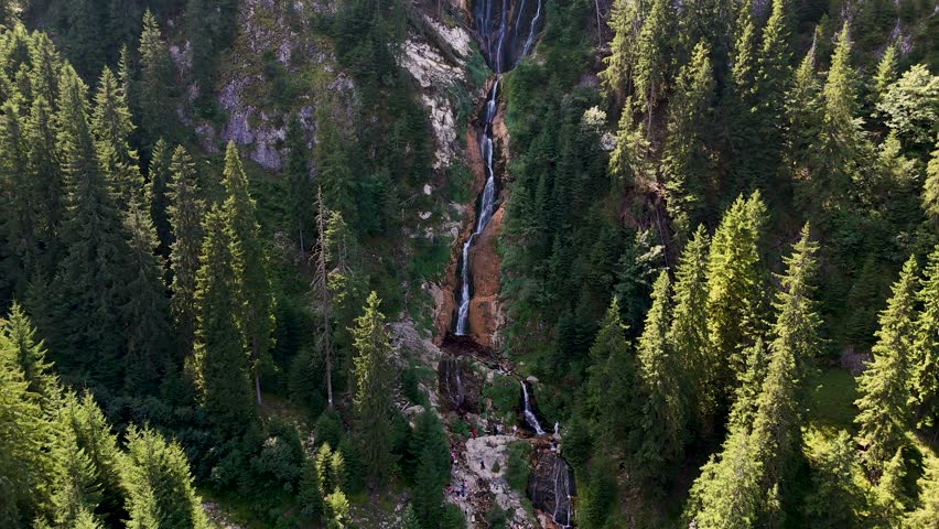 Cinematic aerial reveal of Cascada Cailor and the surrounding landscape of the Rodnei Mountains, Romania