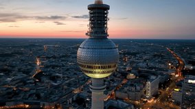 Aerial video shows a vibrant cityscape with a majestic tower famous places architectural landmarks TV Tower, Alexanderplatz at night. Berlin, Germany - Powered by Shutterstock - Get 15% off with code: PIKWIZARD15