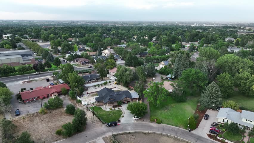 Greeley Colorado suburban homes flyover featuring summer trees.