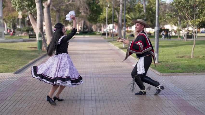 couple of huasos dancing Chilean cueca in the city square, Fiestas Patrias concept