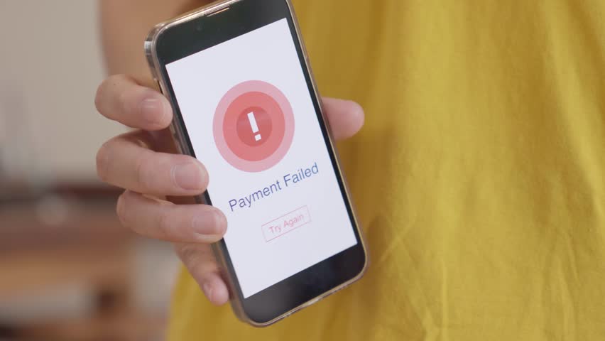 Close up of hand showing payment failed on mobile phone