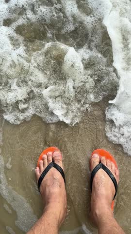 The waves crash against my feet