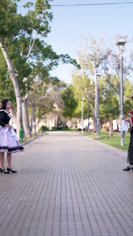couple of huasos dancing Chilean cueca in the city square, Fiestas Patrias concept