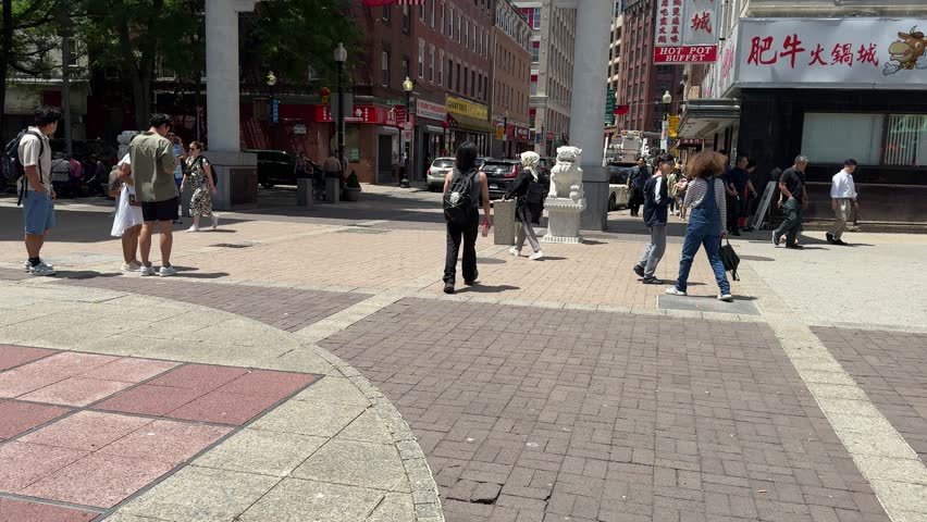 Boston, Massachusetts, USA - July 1 2024: Walking up to the Boston Chinatown gateway on sunny afternoon with blue skies