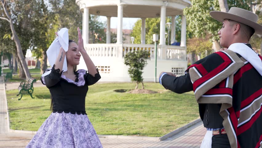 couple of huasos dancing Chilean cueca in the city square, Fiestas Patrias concept