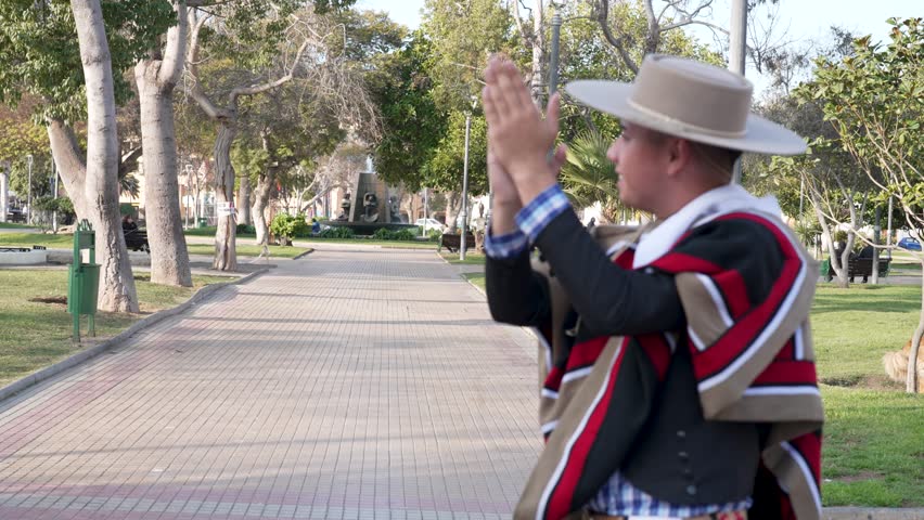 couple of huasos dancing Chilean cueca in the city square, Fiestas Patrias concept