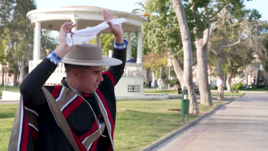 couple of huasos dancing Chilean cueca in the city square, Fiestas Patrias concept
