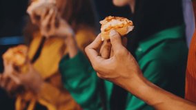 Diverse group of young people eating pizza at house party 80s style, copy space - Powered by Shutterstock - Get 15% off with code: PIKWIZARD15