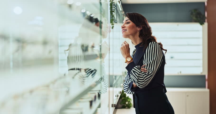 Happy woman, shelf and customer at optometry store for frame choice, vision correction or fashion lens. Client, smile and spectacles in optical shop for decision, eye care or check glasses for health