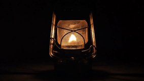 A close-up shot of a kerosene lantern with a black background. - Powered by Shutterstock - Get 15% off with code: PIKWIZARD15