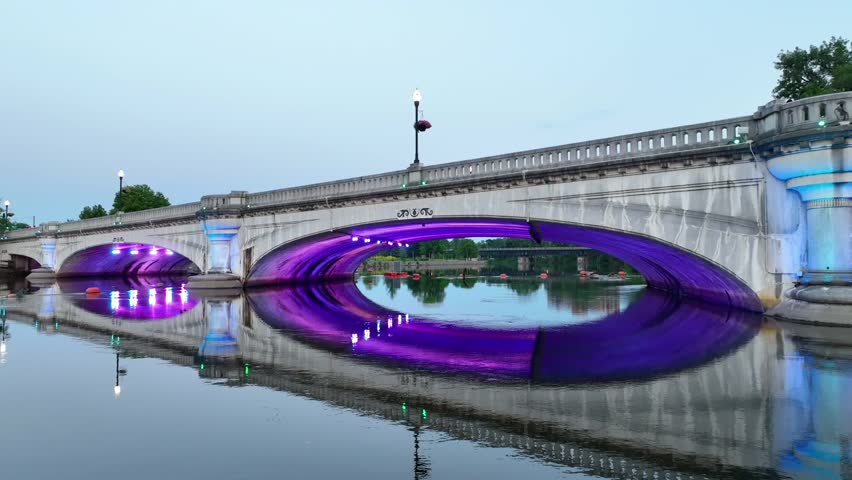 Aerial Pedestal Shot of Illuminated Bridge at South Bend Riverfront at Sunset