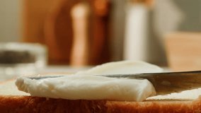 Cream cheese Spreading with knife on toasted bread slice, women hands apply fresh butter cream cheese on a slice of freshly baked bread close up, morning breakfast. - Powered by Shutterstock - Get 15% off with code: PIKWIZARD15