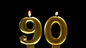 Golden number 90 birthday candle burning against a black background, creating a sleek and elegant celebration scene. - Powered by Shutterstock - Get 15% off with code: PIKWIZARD15