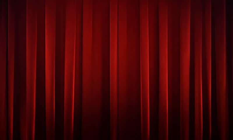 Red Velvet Reveal: A vibrant green screen peeks through the luxurious folds of parted red velvet curtains, setting the stage for captivating presentations and digital creations.