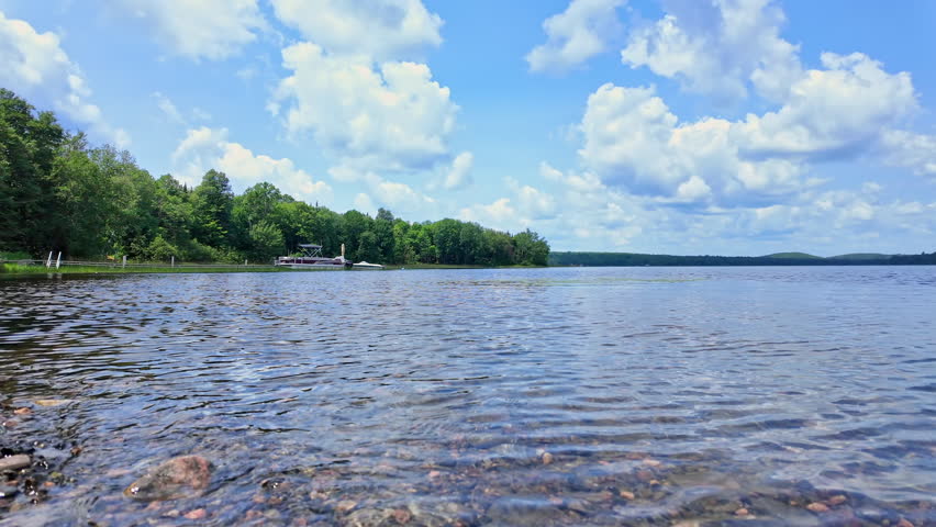 Public Boat Launch to the lake at Municipality of Magnetawan, Canada. Beautiful lake marine and forest with trees. Travel and adventure during summer. Epic panoramic water and green vegetations view.