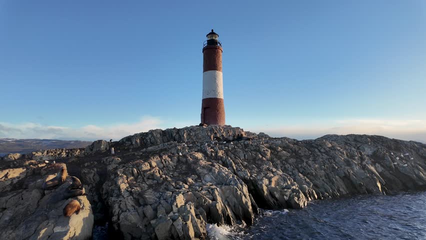Ushuaia Lighthouse At Ushuaia In Tierra Del Fuego Argentina. Amazing Bay Water. Maritime Excursion. Boat Sailing Scene. Ushuaia Lighthouse At Ushuaia In Tierra Del Fuego Argentina.