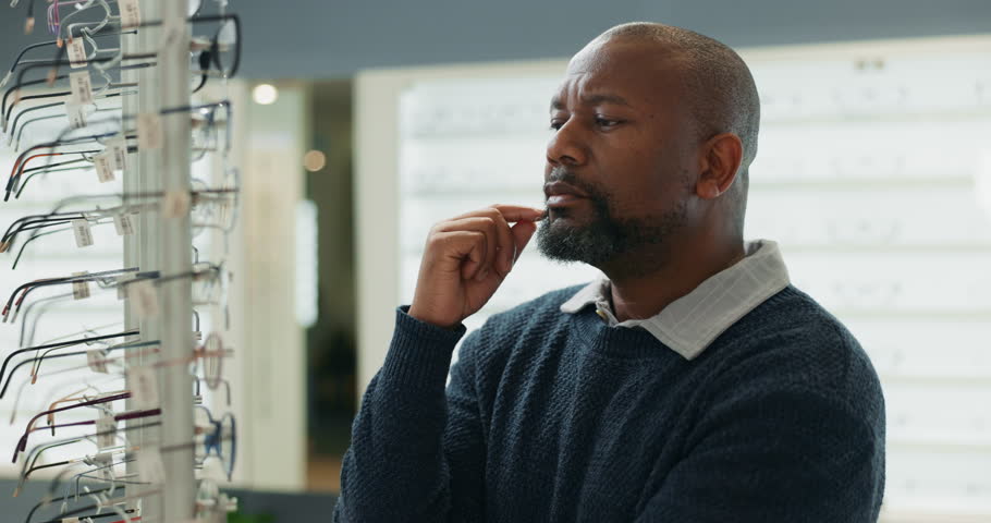 Man, optometry and decision with glasses for eye care, medical professional or optometrist consultation. Male person, spectacles and choice in clinic or ophthalmology center for size, frame and lens