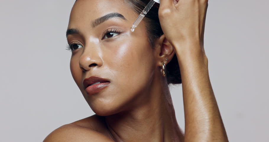 Woman, serum and hydration for skincare, application and cosmetics with facial, glow and transformation. Model, dermatology and hyaluronic acid in studio for skin, face and beauty on white background