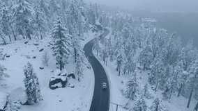 An aerial 4K image captures a tranquil winter setting with a road winding through a snowy forest, presenting a serene and beautiful view of nature in its peaceful and snowy splendor - Powered by Shutterstock - Get 15% off with code: PIKWIZARD15