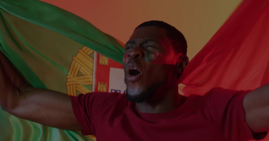 Animation of confetti falling over african american male supporter with flag of portugal. Sport and celebration concept digitally generated video.