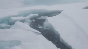 Ice floes slowly breaking apart to make way for an icebreaker ship at the north pole. Dark water of the arctic ocean revealed as the ice breaks up - Powered by Shutterstock - Get 15% off with code: PIKWIZARD15