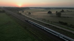 Passenger Train Running Along Tracks at Autumn Sunrise with Fog in Nearby Fields. - Powered by Shutterstock - Get 15% off with code: PIKWIZARD15
