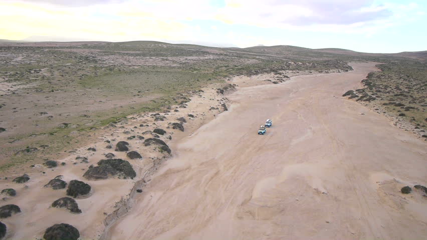 AERIAL: cars in a dry riverbed Royalty-Free Stock Footage #3589502