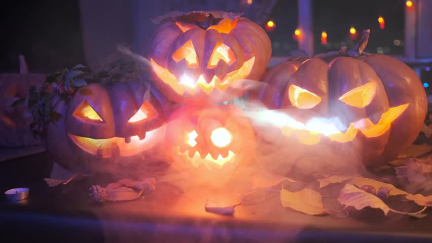 Close up cool Halloween pumpkins flashes with smoke, on night party, decorating the celebration.