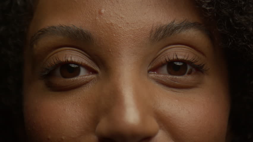 Close-up of a woman wide-open eyes with natural lashes