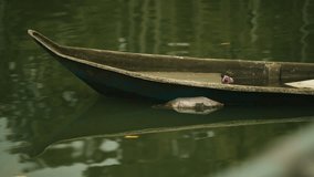 Bow Of An Old Wooden Canoe Boat Over Lake. Close-up Shot - Powered by Shutterstock - Get 15% off with code: PIKWIZARD15