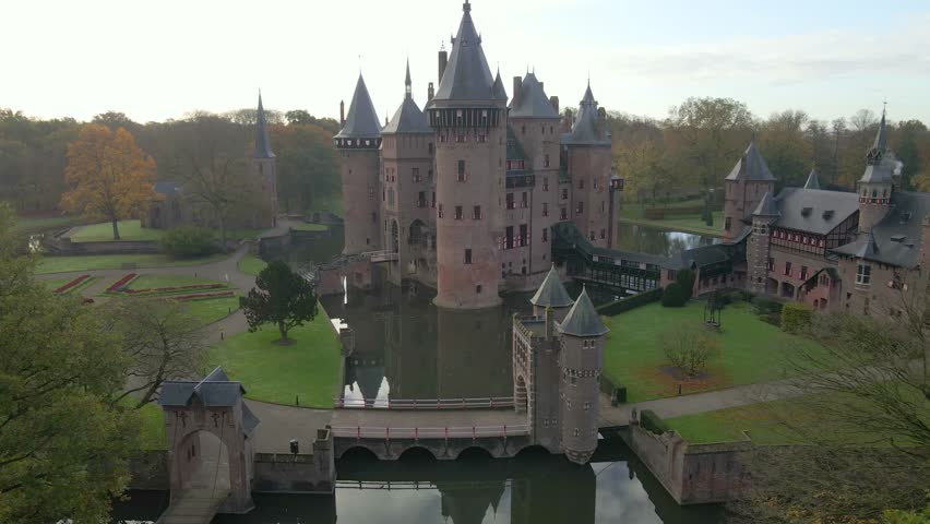 Aerial view of medieval castle surrounded by trees and towers in Haarzuilens, Utrecht, Netherlands.