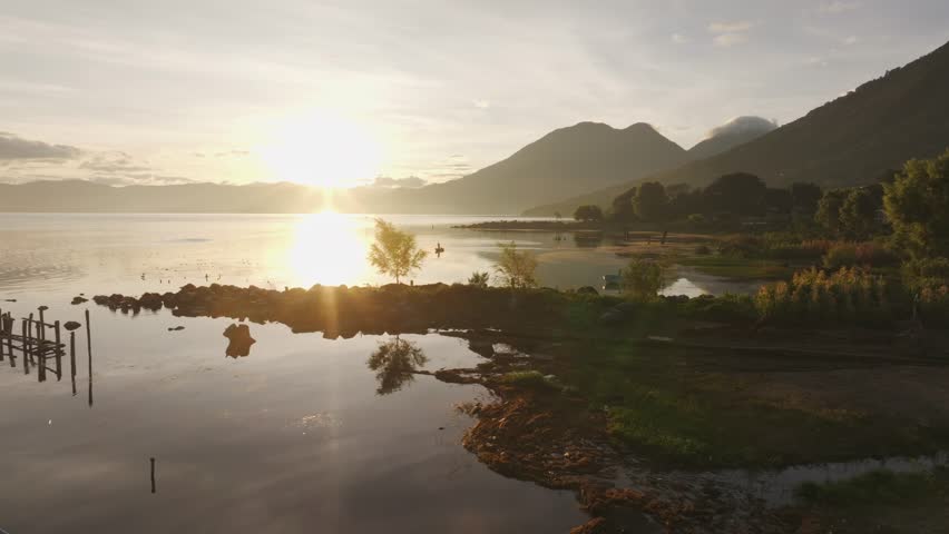 Aerial view of sunrise over Lake Atitlan with majestic volcanoes, San Pedro La Laguna, Solola, Guatemala.