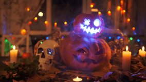 Large and small pumpkins stacked on top of each other next by Halloween decorations, skulls, candles and festive lights create a mood of horror and fun for a night party. - Powered by Shutterstock - Get 15% off with code: PIKWIZARD15