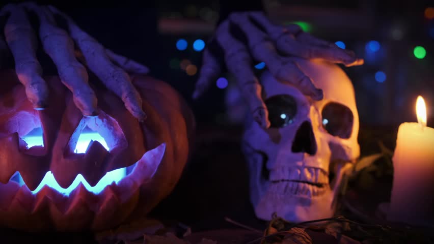 Creepy fingers caress pumpkin and skull, bringing terror to holiday parties halloween on flickering candles and colorful festival lights.