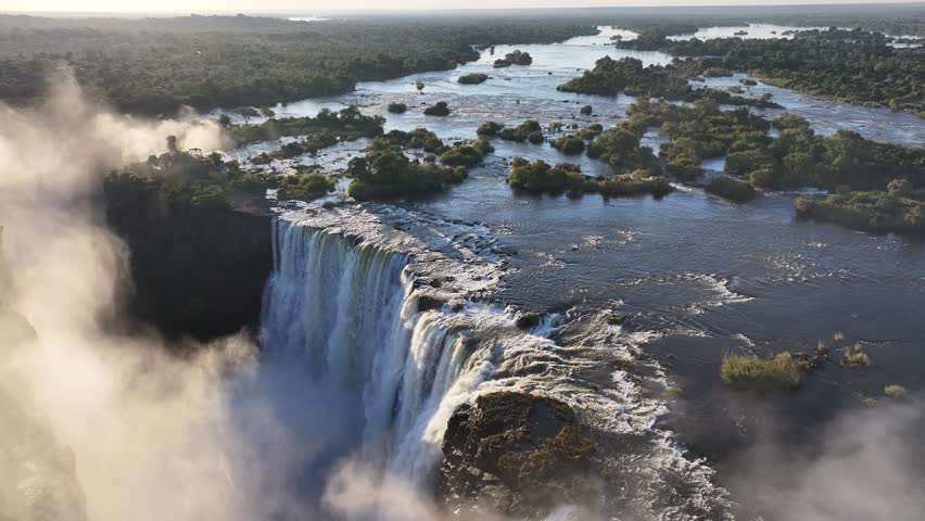 Scenic Water Falls At Victoria Falls  Zimbabwe. Experience The Majestic Flow Of Waterfalls With Lush Greenery. Landscape Clouds Waterfall. Victoria Falls Zimbabwe. Victoria Falls Zambia.