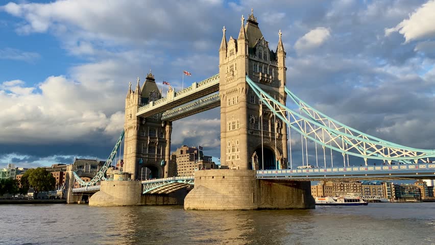 London Tower Bridge across River Thames busy with traffic people