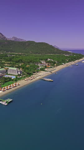 Aerial view of bright sunny day illuminates tropical beach of luxurious resort
