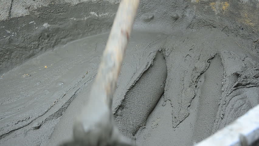 worker is mixing the cement close up