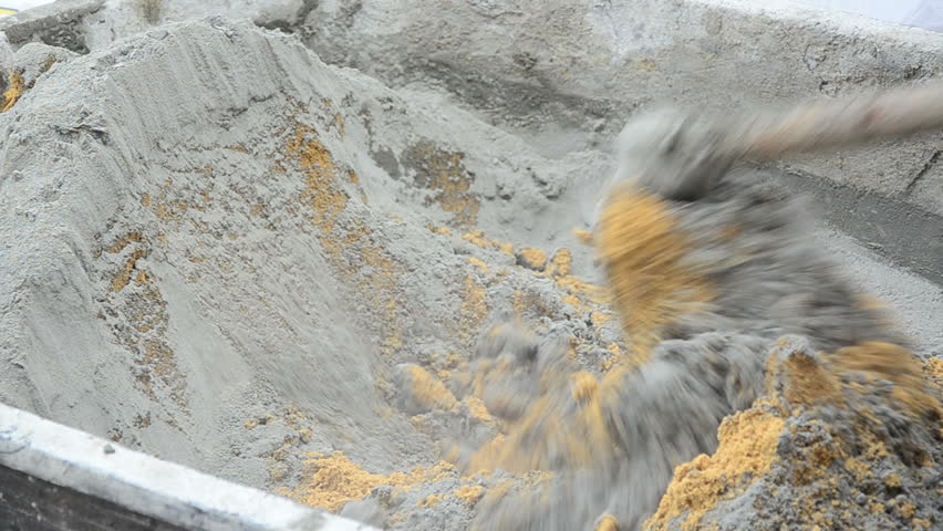 worker is mixing the cement close up