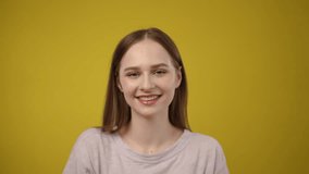A joyful girl is playfully posing with a bright lemon on top of her head, set against a vivid yellow backdrop - Powered by Shutterstock - Get 15% off with code: PIKWIZARD15